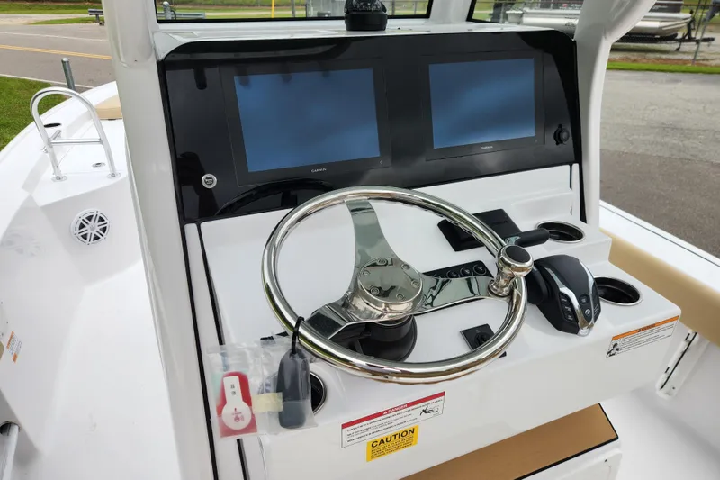 Slide: The Image of Steering console of 2026 Sportsman Masters 247 Bay Boat with dual screens and controls. - 18