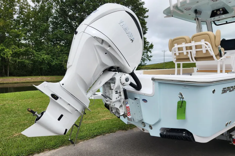 Slide: The Image of 2026 Sportsman Masters 247 Bay Boat with Yamaha outboard engine, parked on grass. - 3