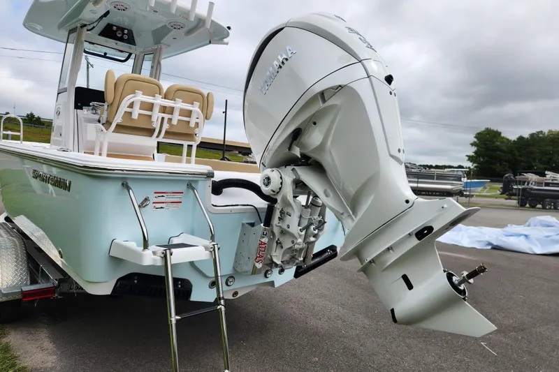 Slide: The Image of 2026 Sportsman Masters 247 Bay Boat with powerful outboard motor, parked on a trailer. - 4