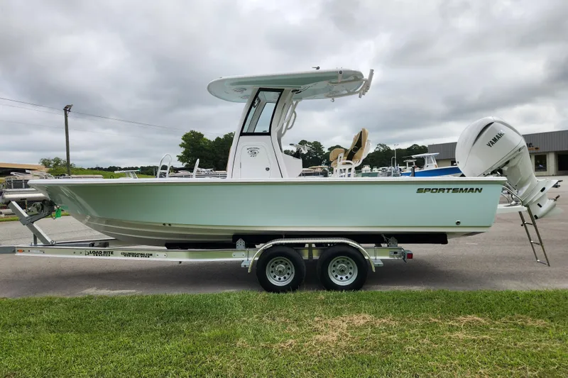 Slide: The Image of 2026 Sportsman Masters 247 Bay Boat on trailer, side view, cloudy sky background. - 6