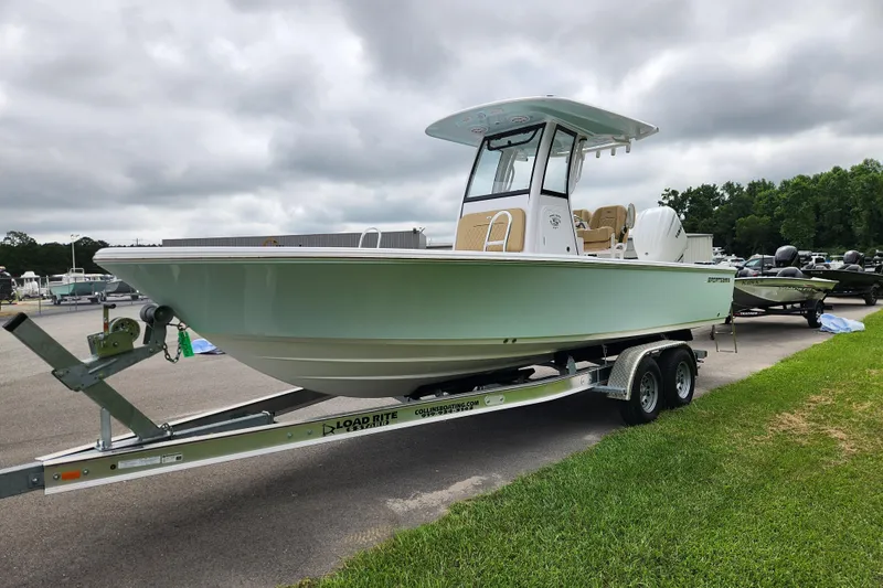 Slide: The Image of 2026 Sportsman Masters 247 Bay Boat on trailer, parked outdoors under cloudy sky. - 7