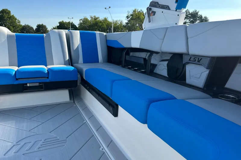 Slide: The Image of 2025 Malibu Wakesetter 23 LSV interior with blue and gray seating, showcasing luxury design. - 10