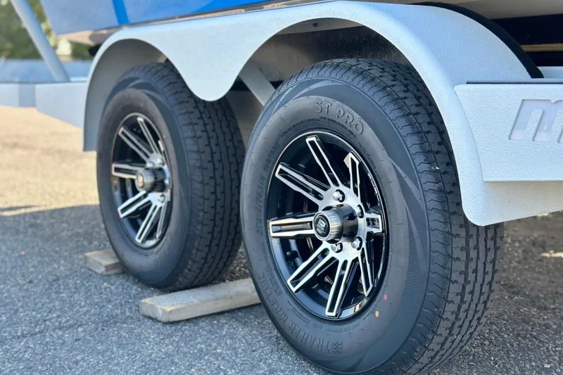 Slide: The Image of Trailer wheels of 2025 Malibu Wakesetter 23 LSV, featuring sleek black rims. - 4