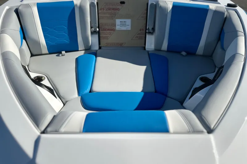 Slide: The Image of 2025 Malibu Wakesetter 23 LSV boat interior with blue and gray seating. - 5