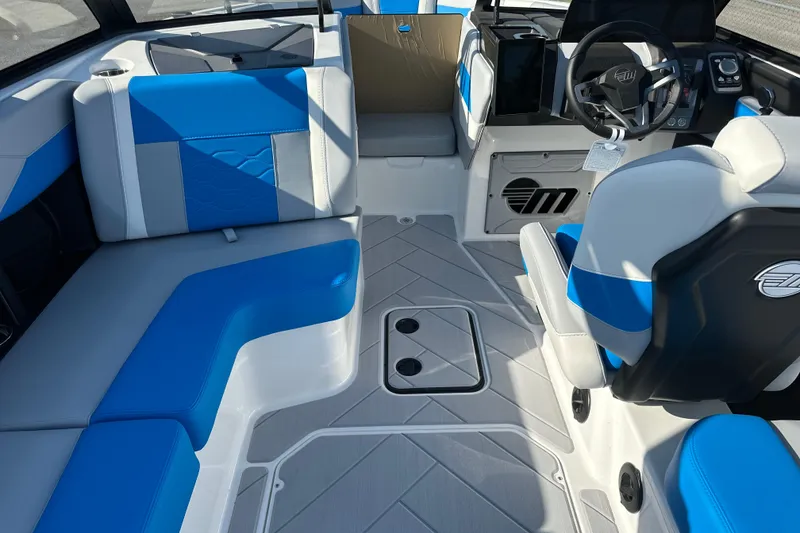 Slide: The Image of 2025 Malibu Wakesetter 23 LSV interior with blue and gray seating, modern dashboard. - 7