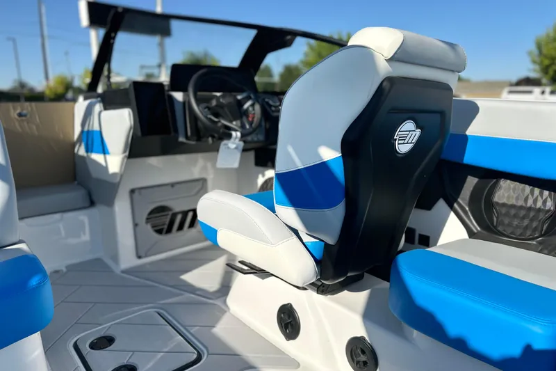 Slide: The Image of 2025 Malibu Wakesetter 23 LSV interior with blue and white seating, modern dashboard. - 8