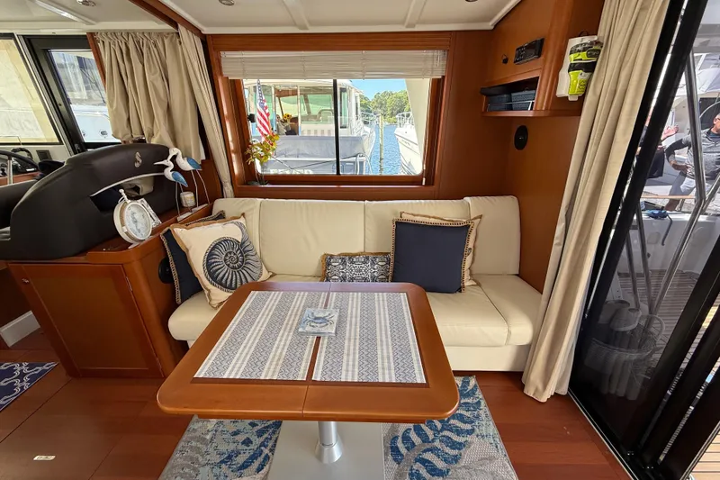 Slide: The Image of Interior of 2018 Beneteau Swift Trawler 44 with cozy seating and nautical decor. - 14