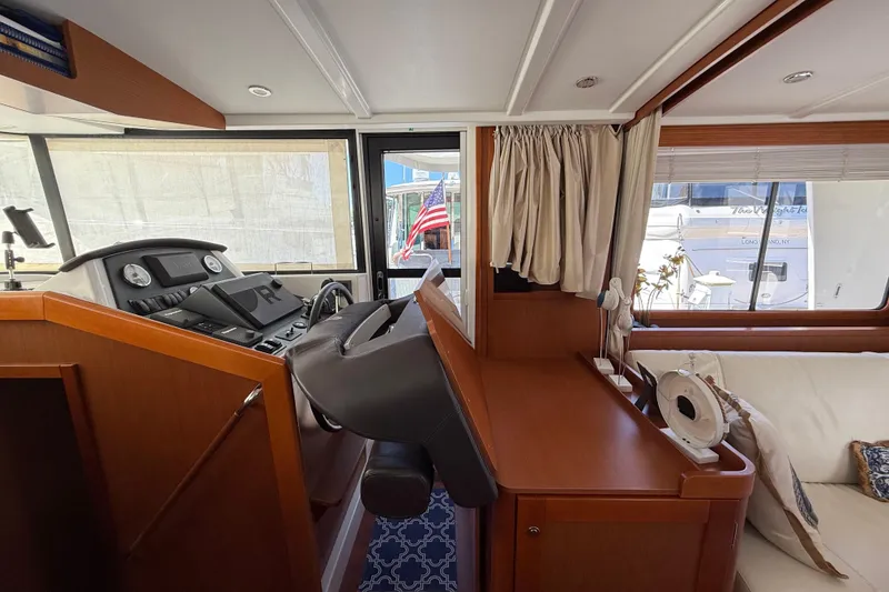 Slide: The Image of Interior of 2018 Beneteau Swift Trawler 44 with helm station and seating area. - 18