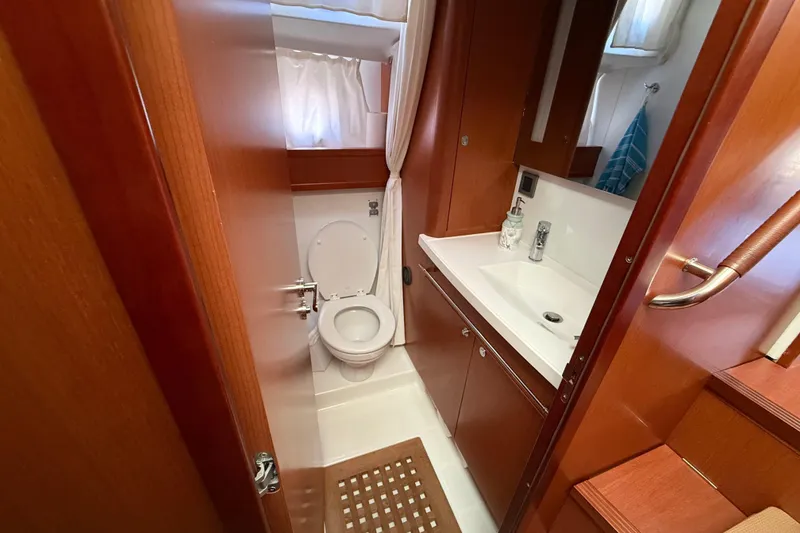 Slide: The Image of 2018 Beneteau Swift Trawler 44 bathroom with wooden cabinetry and modern fixtures. - 23