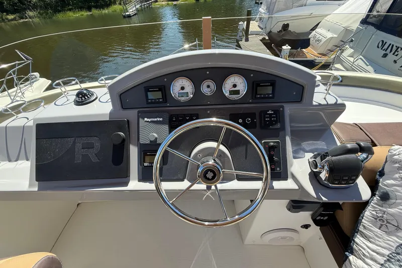 Slide: The Image of Helm of 2018 Beneteau Swift Trawler 44 with navigational controls and steering wheel. - 30