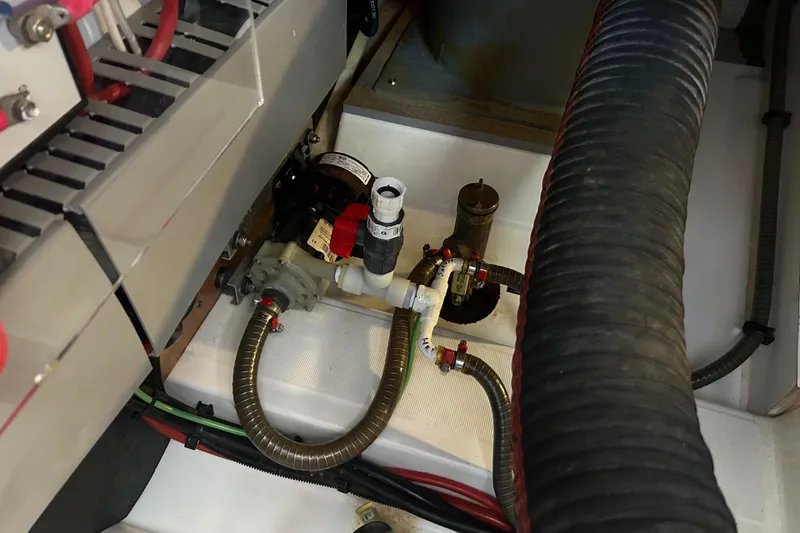 Slide: The Image of Engine compartment of 2018 Beneteau Swift Trawler 44, showcasing mechanical components and hoses. - 43