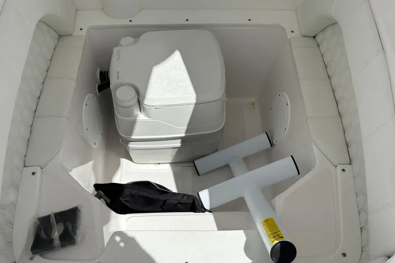 Slide: The Image of Interior storage compartment of 2026 Glasstream 280 Pro-XS boat with portable toilet. - 13