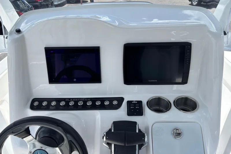 Slide: The Image of 2026 Glasstream 280 Pro-XS boat dashboard with dual screens and control panel. - 17