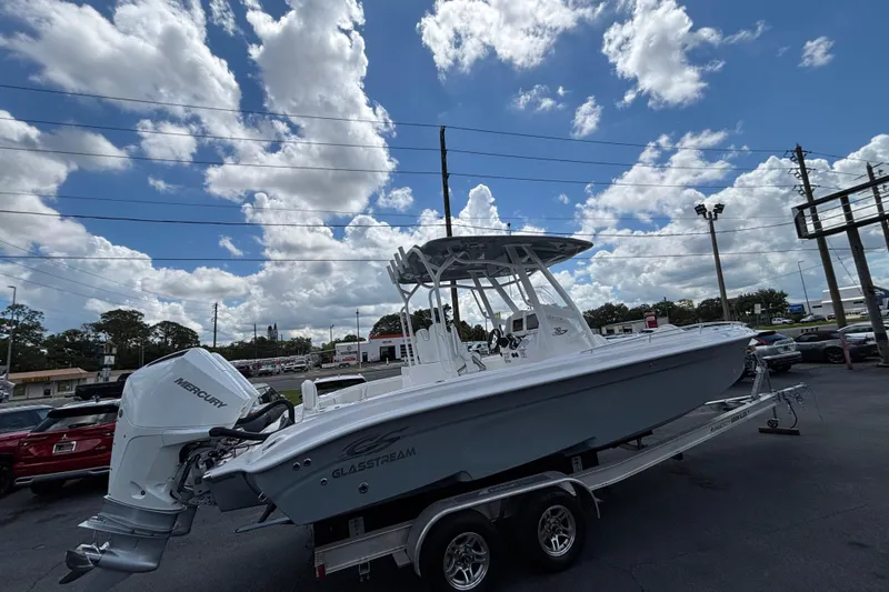 Slide: The Image of 2026 Glasstream 280 Pro-XS boat on trailer under a partly cloudy sky. - 4
