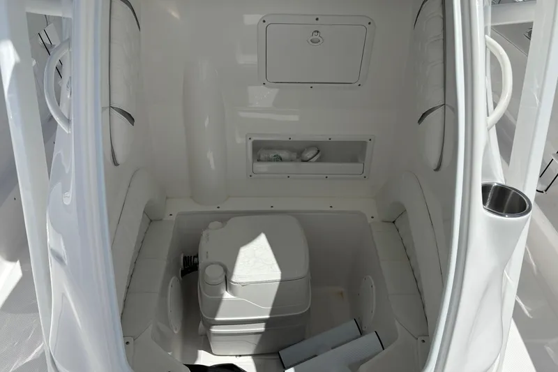 Slide: The Image of Interior of 2026 Glasstream 280 Pro-XS boat featuring compact marine toilet. - 6