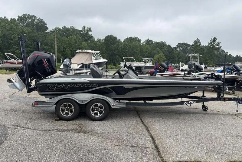 Slide: The Image of 2019 Nitro Z20 boat on trailer, parked in a marina with other boats. - 3