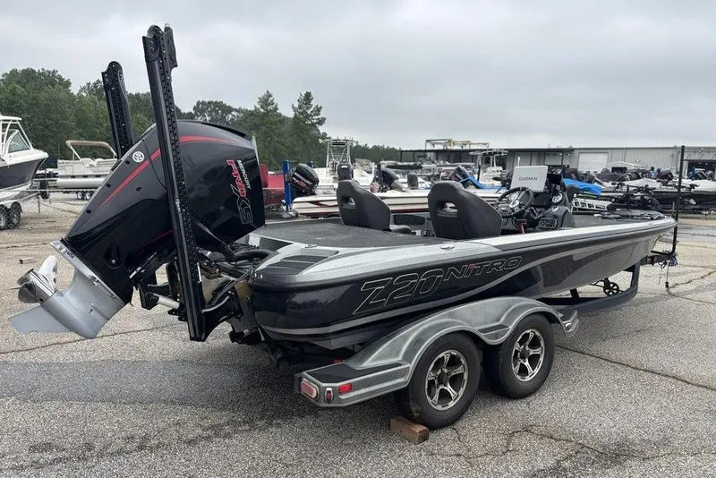 Slide: The Image of 2019 Nitro Z20 boat with trailer, parked outdoors, featuring a powerful outboard motor. - 5