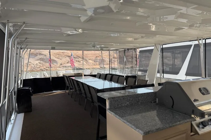 Slide: The Image of Luxurious 2025 Sumerset Relentless yacht interior with dining area and grill, overlooking scenic views. - 12