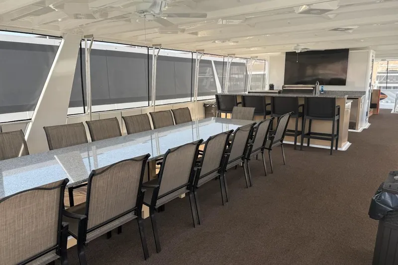 Slide: The Image of Luxurious Sumerset 2025 yacht interior with elegant dining area and modern bar setup. - 13