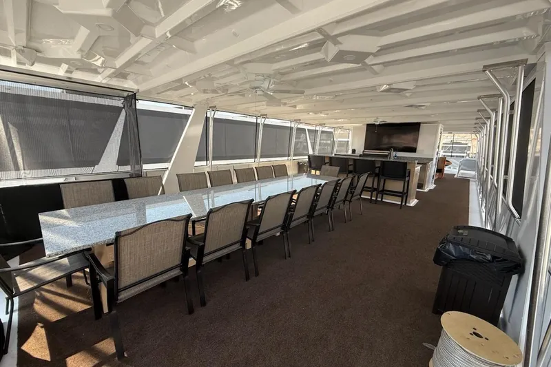 Slide: The Image of 2025 Sumerset Relentless yacht interior with long dining table and modern amenities. - 14