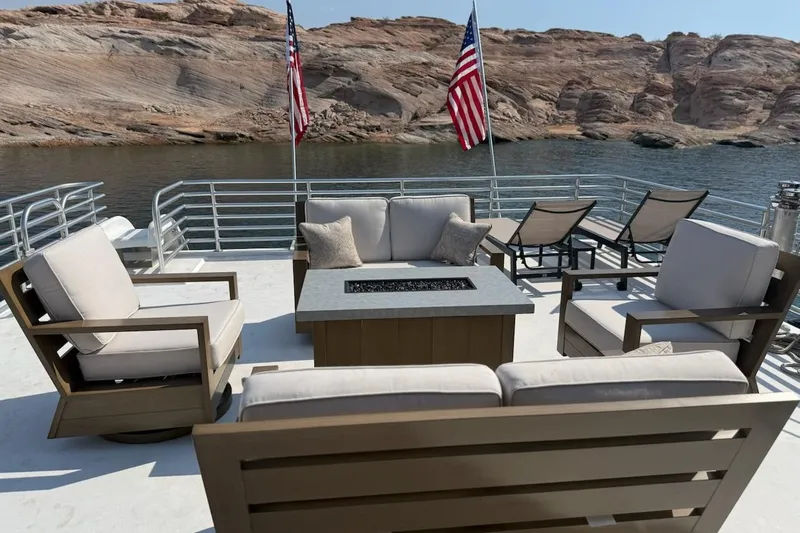 Slide: The Image of Outdoor seating on Sumerset Relentless Multiple Shares 2025 houseboat, with scenic lake and rock view. - 17