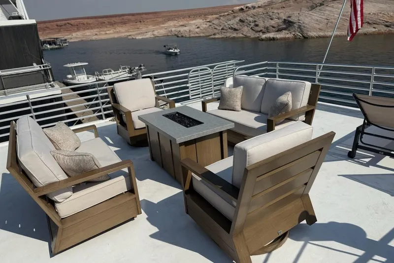 Slide: The Image of Luxury outdoor seating on Sumerset Relentless Multiple Shares houseboat, 2025 model, by a scenic lake. - 18