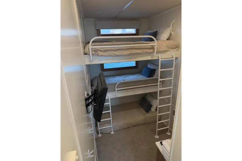 Slide: The Image of Bunk beds in 2025 Sumerset Relentless Multiple Shares houseboat cabin, featuring a TV and window view. - 21