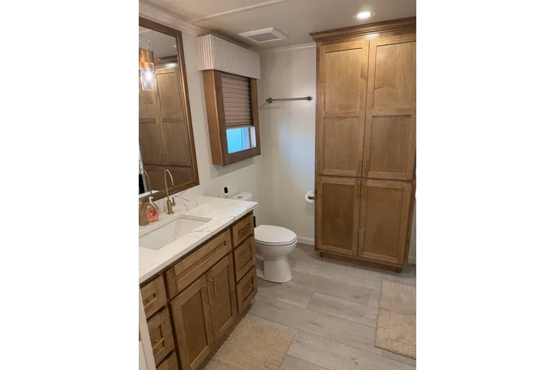 Slide: The Image of Modern bathroom in 2025 Sumerset Relentless Multiple Shares, featuring wood cabinetry and marble countertop. - 24