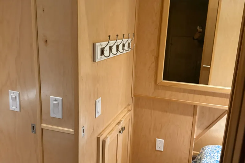 Slide: The Image of Interior of 2025 Sumerset Relentless Multiple Shares with wooden walls, hooks, and mirror. - 28