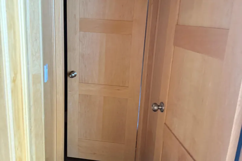 Slide: The Image of Wooden interior doors with metal knobs in a Sumerset Relentless Multiple Shares 2025 model. - 30