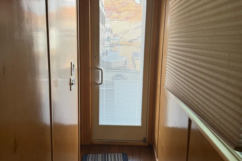 Slide: The Image of Narrow hallway with wooden walls and glass door on Sumerset Relentless Multiple Shares, 2025 model. - 31