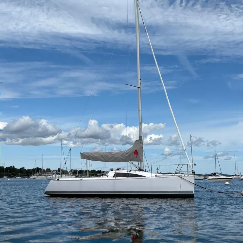 The Image of 2018 Catalina 275 Sport sailboat on calm water under a blue sky. - 0