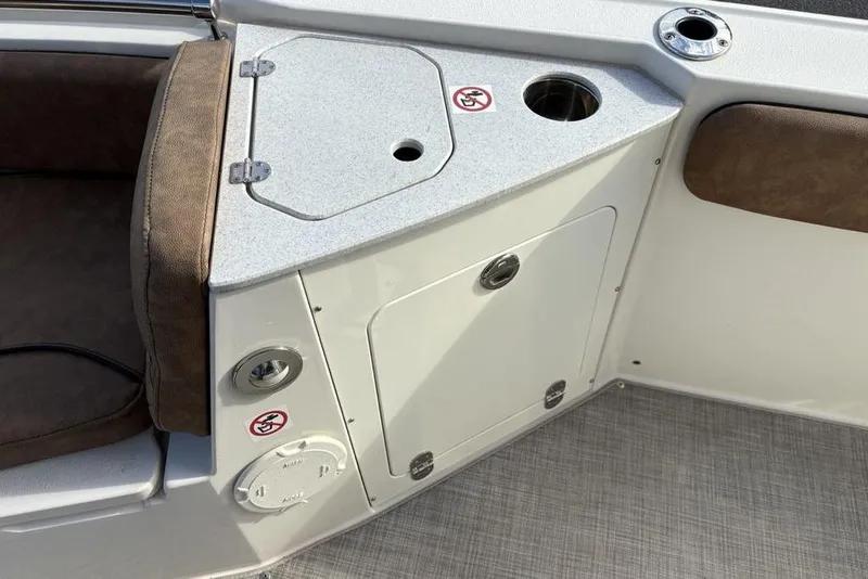 Slide: The Image of 2021 Stingray 236CC boat interior with storage compartment and seating area. - 10