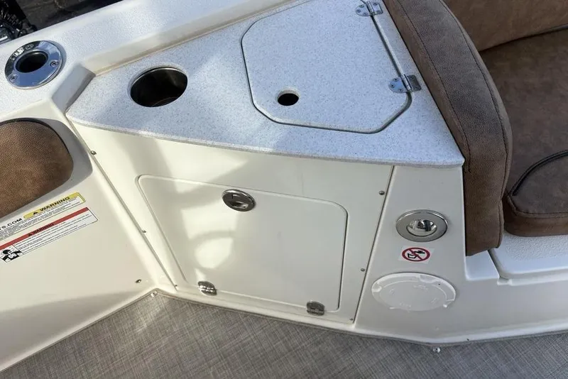 Slide: The Image of Interior view of a 2021 Stingray 236CC boat with seating and storage compartments. - 11