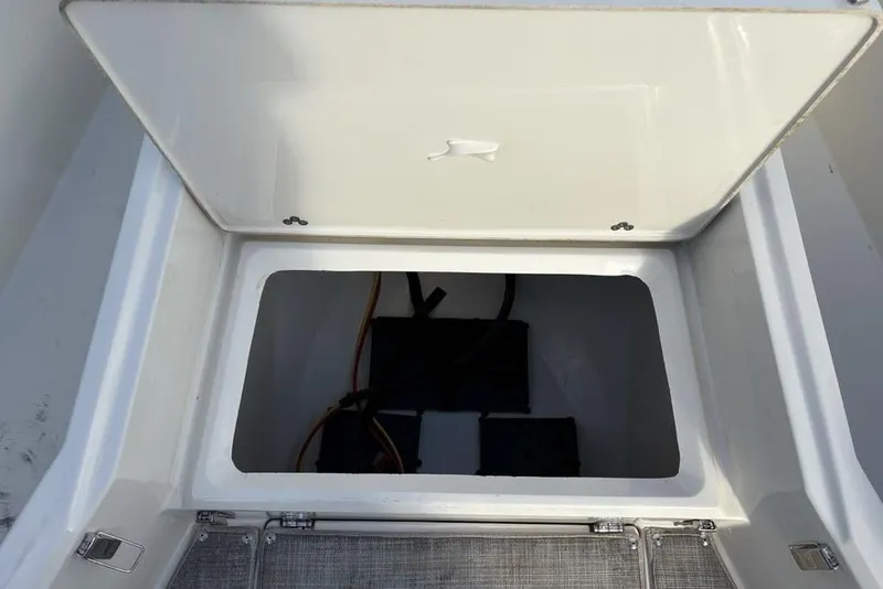 Slide: The Image of Open storage compartment on a 2021 Stingray 236CC boat, showing interior space. - 2