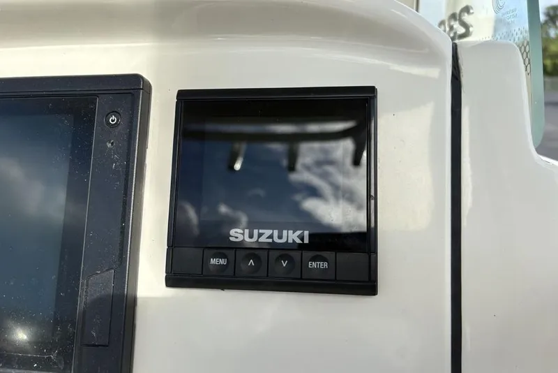 Slide: The Image of Suzuki control panel on 2021 Stingray 236CC boat dashboard. - 23
