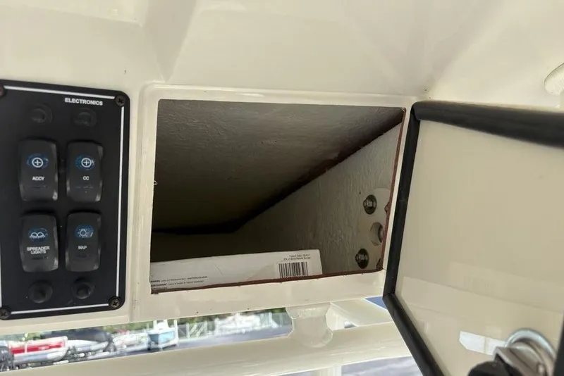 Slide: The Image of 2021 Stingray 236CC electronics panel with open storage compartment. - 25