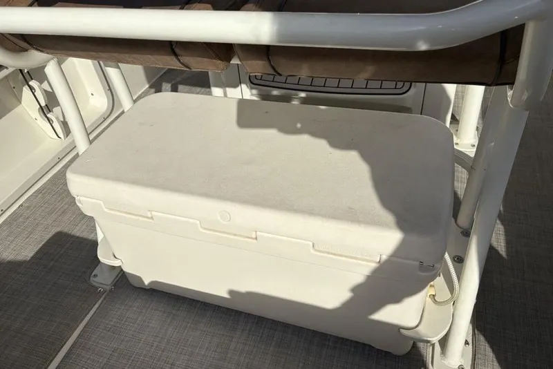 Slide: The Image of 2021 Stingray 236CC boat interior with white cooler under seat. - 29