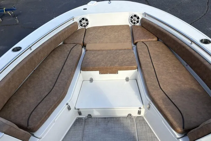 Slide: The Image of 2021 Stingray 236CC boat interior with brown cushioned seating and stainless steel railings. - 3