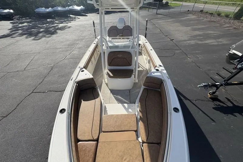 Slide: The Image of 2021 Stingray 236CC boat with spacious seating, parked on asphalt. - 30