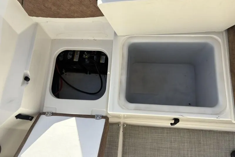 Slide: The Image of Open storage compartments on a 2021 Stingray 236CC boat. - 34