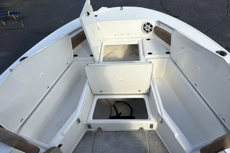 Slide: The Image of 2021 Stingray 236CC boat interior with open storage compartments and speaker. - 4