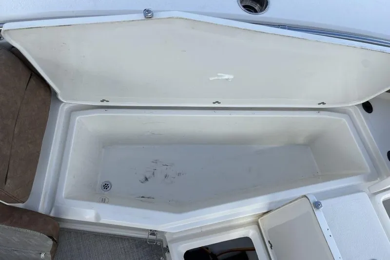 Slide: The Image of Open storage compartment on a 2021 Stingray 236CC boat, featuring spacious interior. - 5