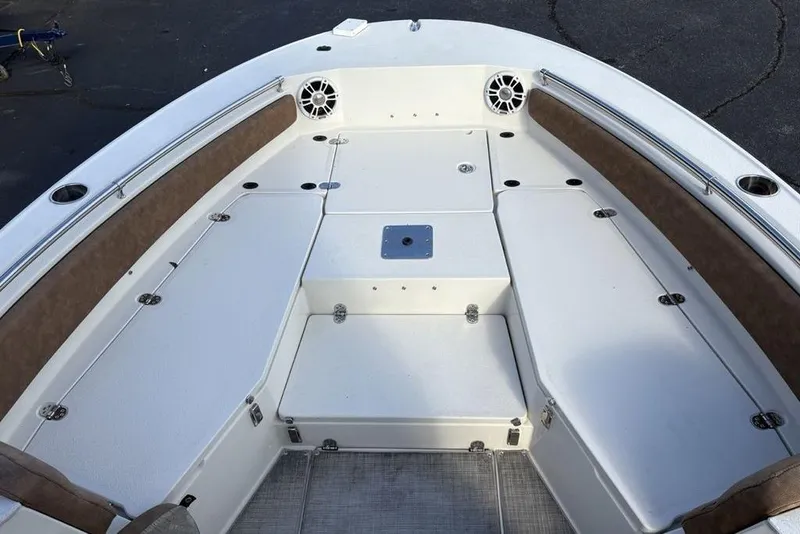 Slide: The Image of 2021 Stingray 236CC boat interior with cushioned seating and storage compartments. - 6