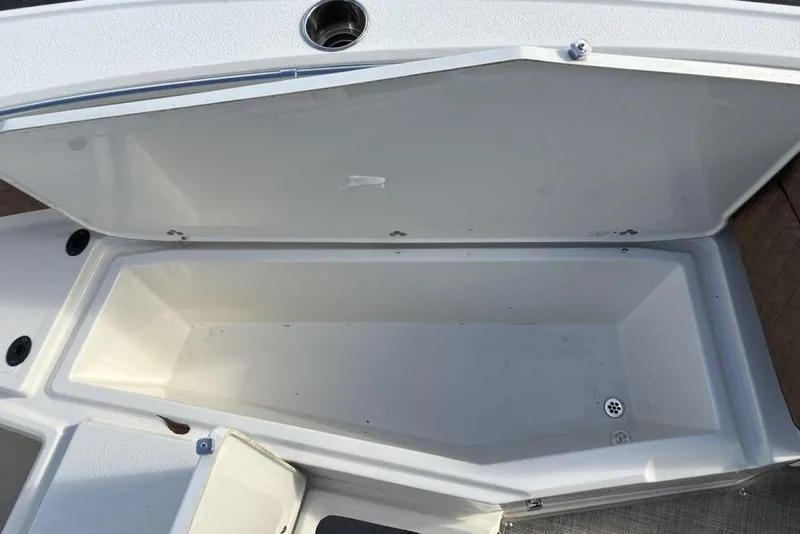 Slide: The Image of Open storage compartment on a 2021 Stingray 236CC boat, showcasing interior space. - 7