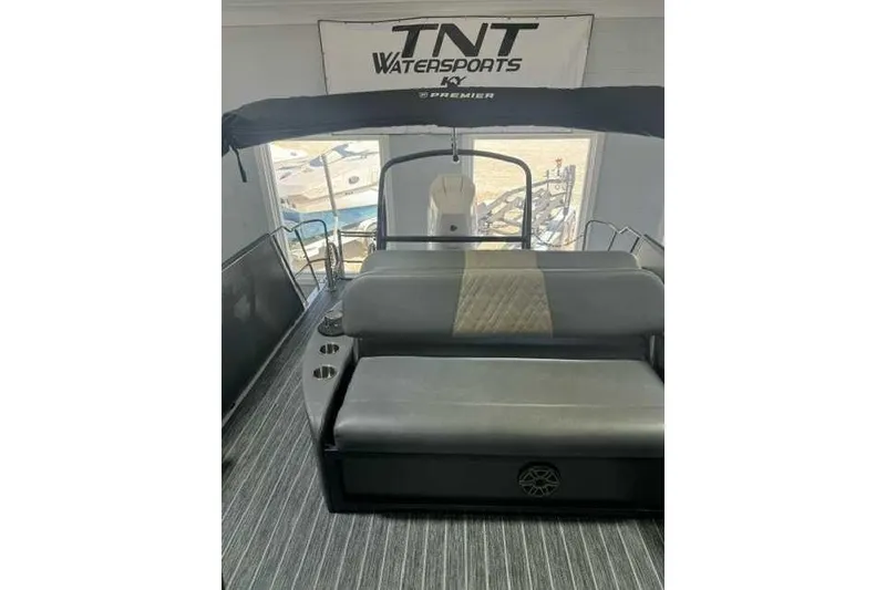 Slide: The Image of 2024 Premier 250 Intrigue RL boat interior with seating and TNT Watersports banner. - 5