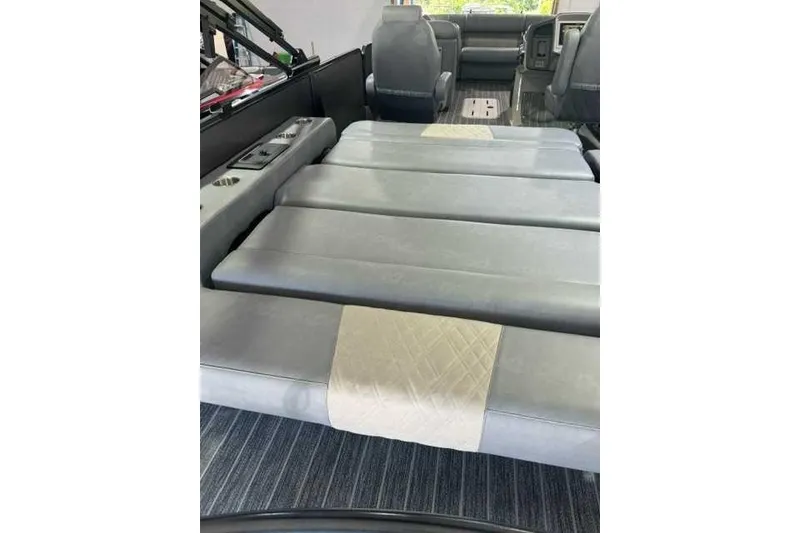 Slide: The Image of 2024 Premier 250 Intrigue RL interior with gray seating and cup holders. - 6