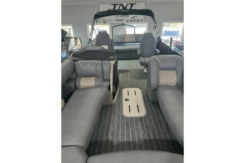 Slide: The Image of 2024 Premier 250 Intrigue RL pontoon boat interior with luxurious seating and modern design. - 8