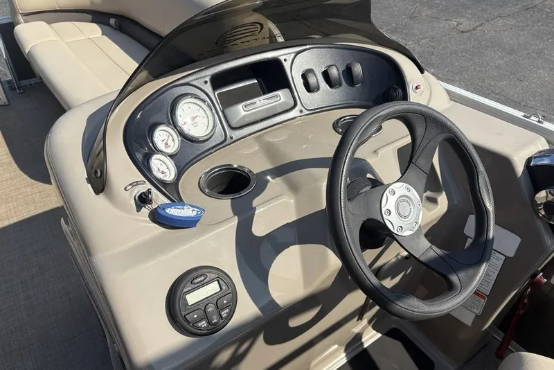 Slide: The Image of 2021 Sun Tracker Party Barge® 18 DLX dashboard with steering wheel and gauges. - 15