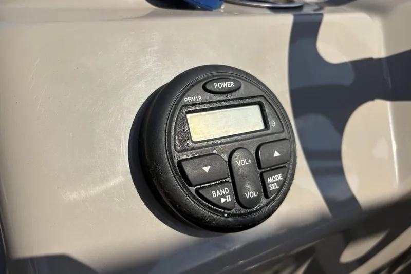 Slide: The Image of Control panel on 2021 Sun Tracker Party Barge® 18 DLX, featuring power and volume buttons. - 16